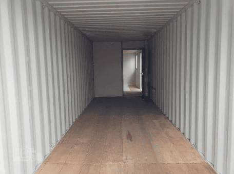 Office container interior with wood floor and office door installed